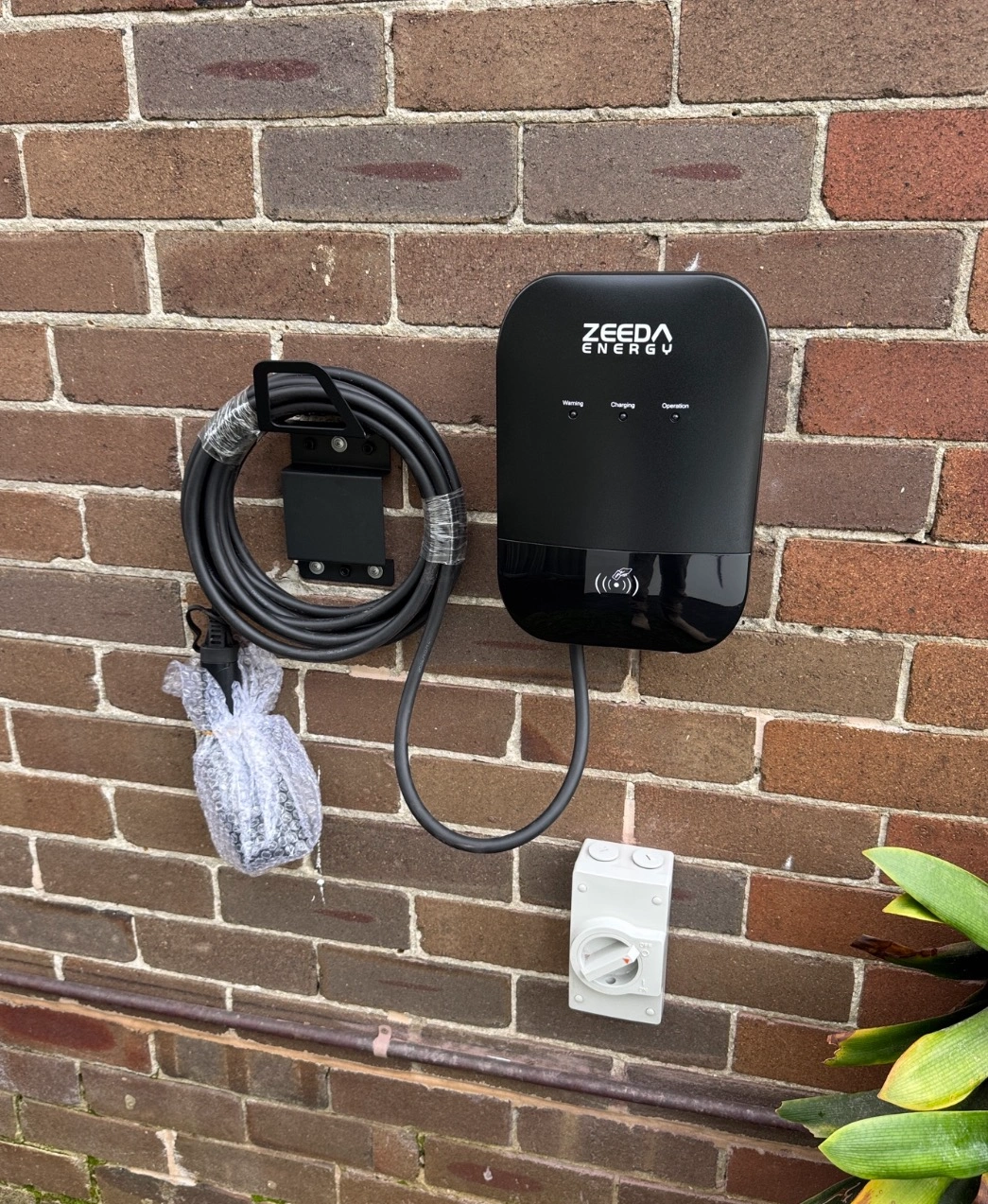 Wall-mounted Zappi EV charger installed by Russo Electrical on an exterior brick wall